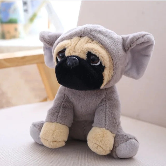 Plush toy with pug face and elephant ears on a light surface