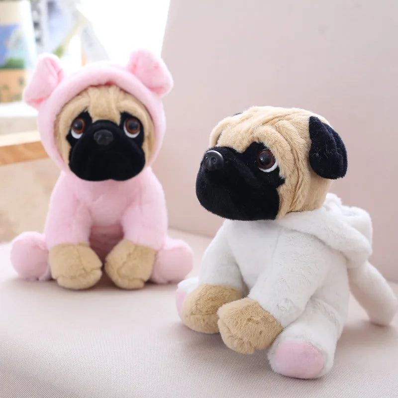 Two plush toys resembling pugs, one in a pink outfit and the other in a white outfit, on a light background.