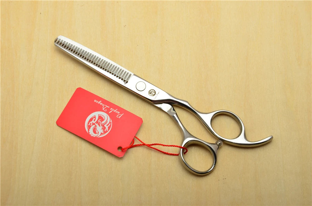Hair cutting scissors with a red tag on a wooden surface