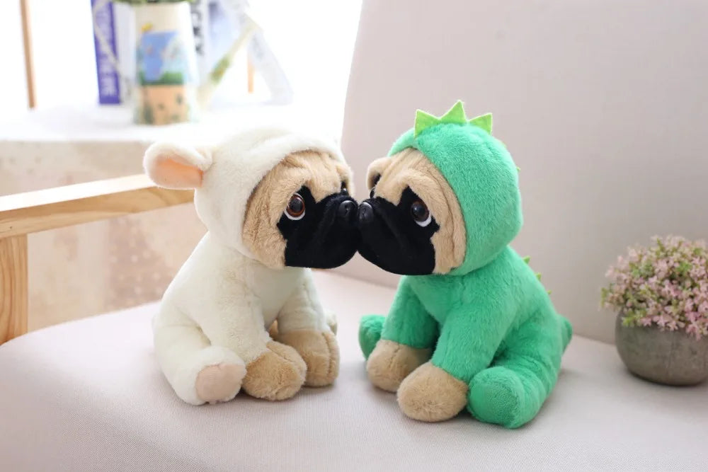 Two plush toys, one white and one green, sitting on a surface with a blurred background.