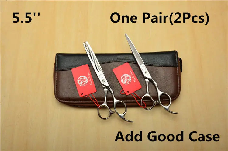 Two pairs of scissors with red tags on a brown case against a beige background.