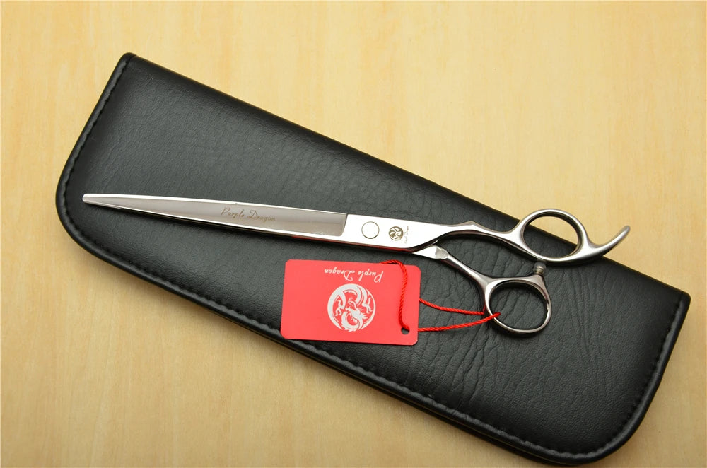 Hair cutting scissors with a black case on a wooden surface
