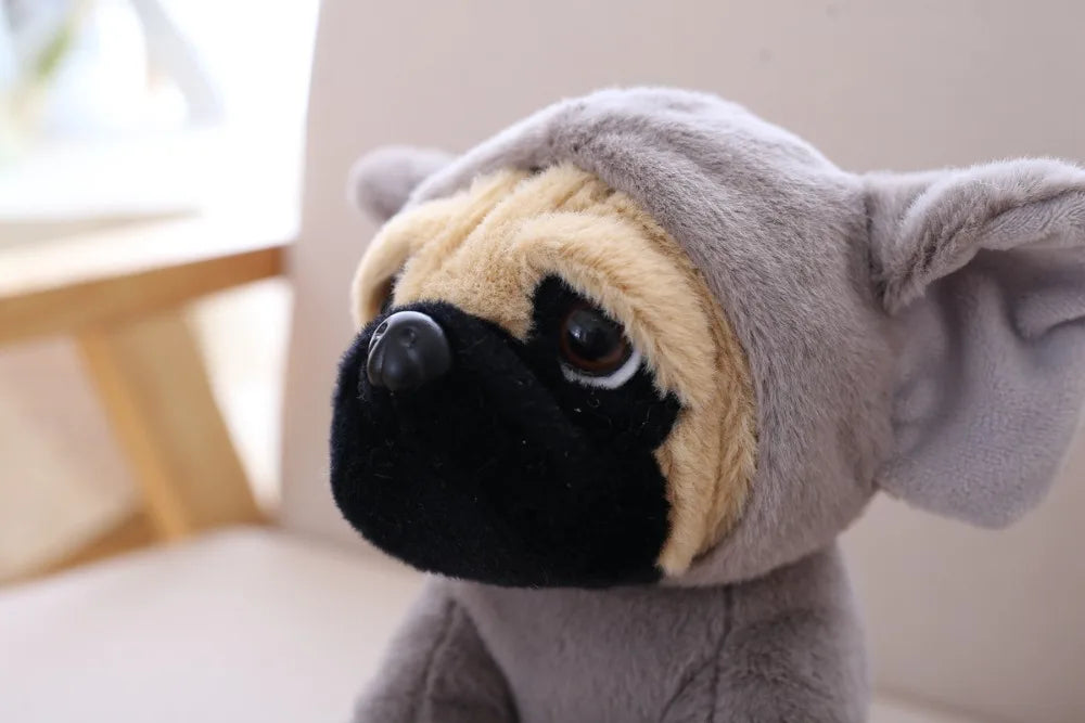 Plush toy resembling a pug with a hood in a neutral setting