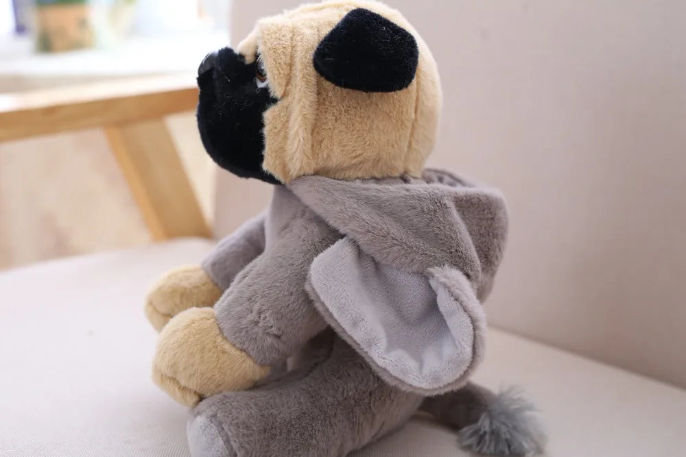 Plush toy resembling a sloth on a white surface with a blurred background