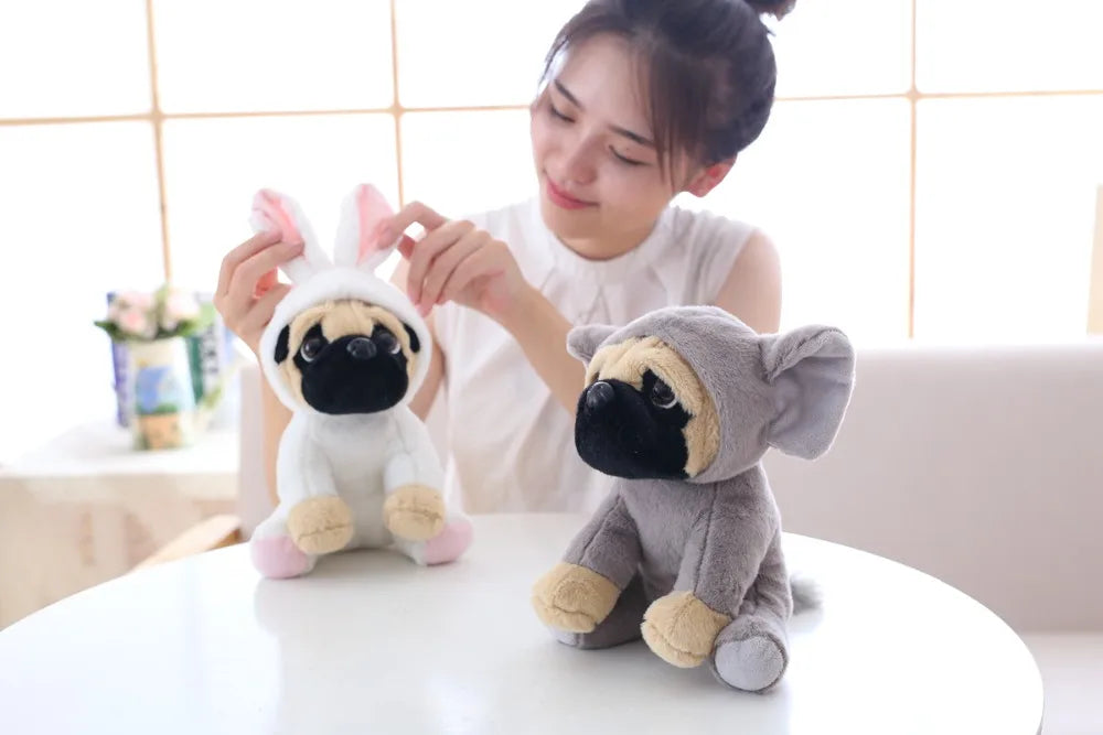 Woman holding two plush dog toys on a table with a light-colored wall background