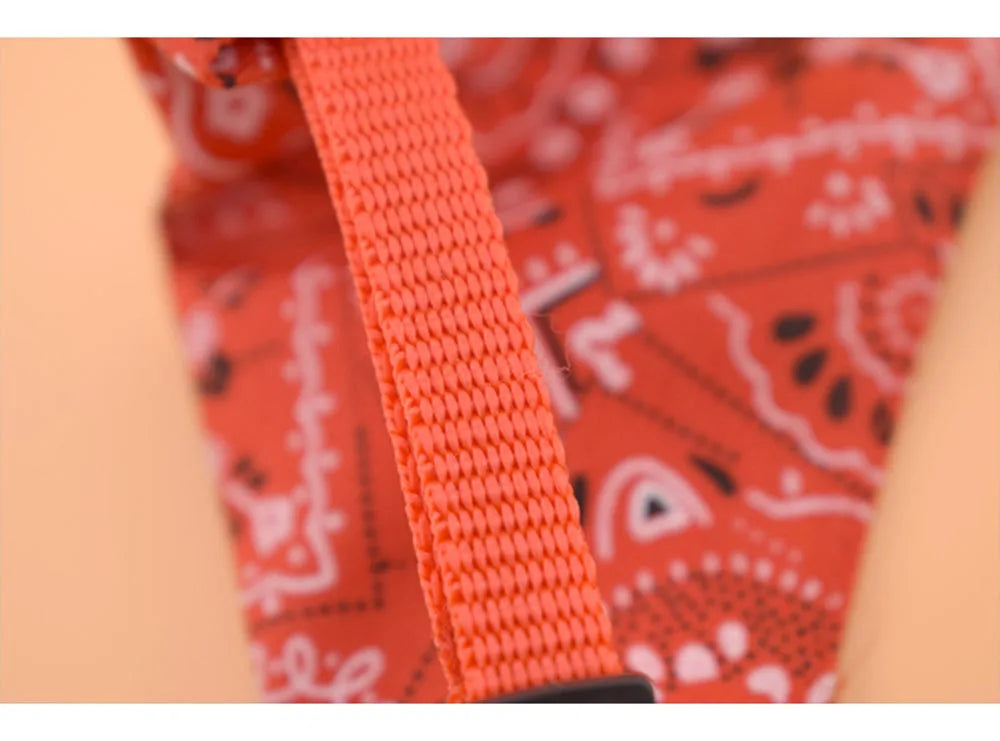 Close-up of an orange strap on a red bandana with white patterns