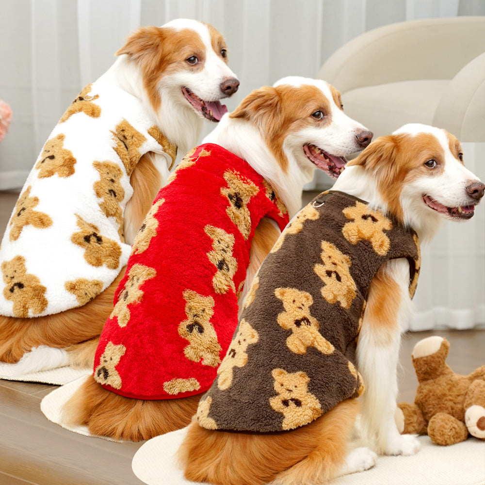 Three dogs wearing teddy bear patterned sweaters in red, white, and brown.