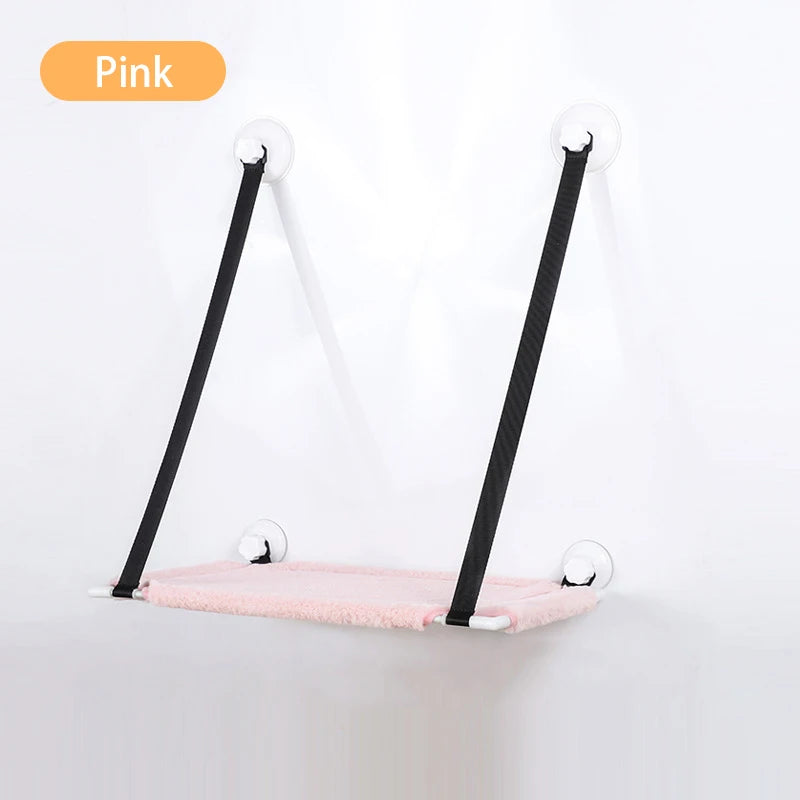 pink lounger suction cupped to white wall with black support straps