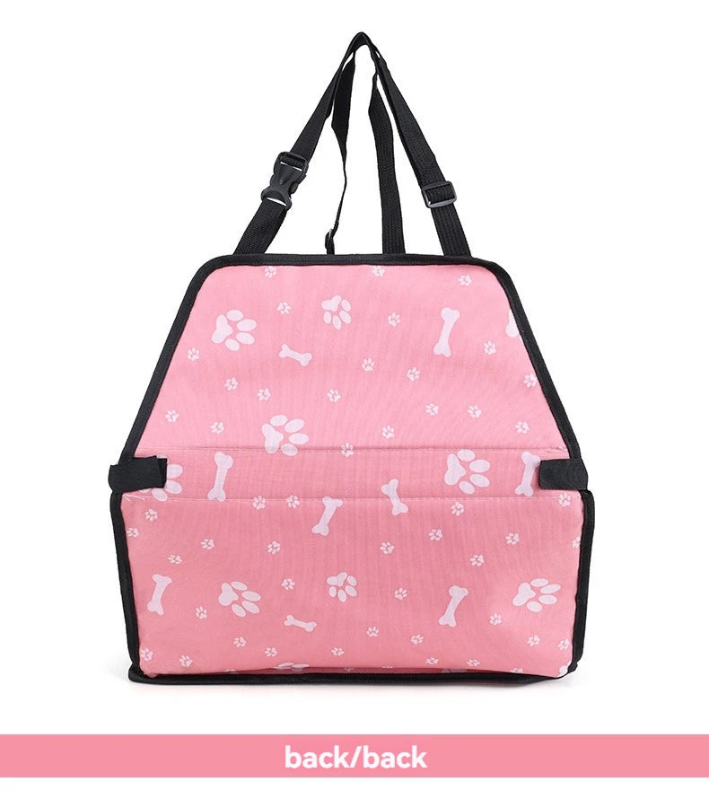 Pink pet carrier with paw and bone patterns on a white background