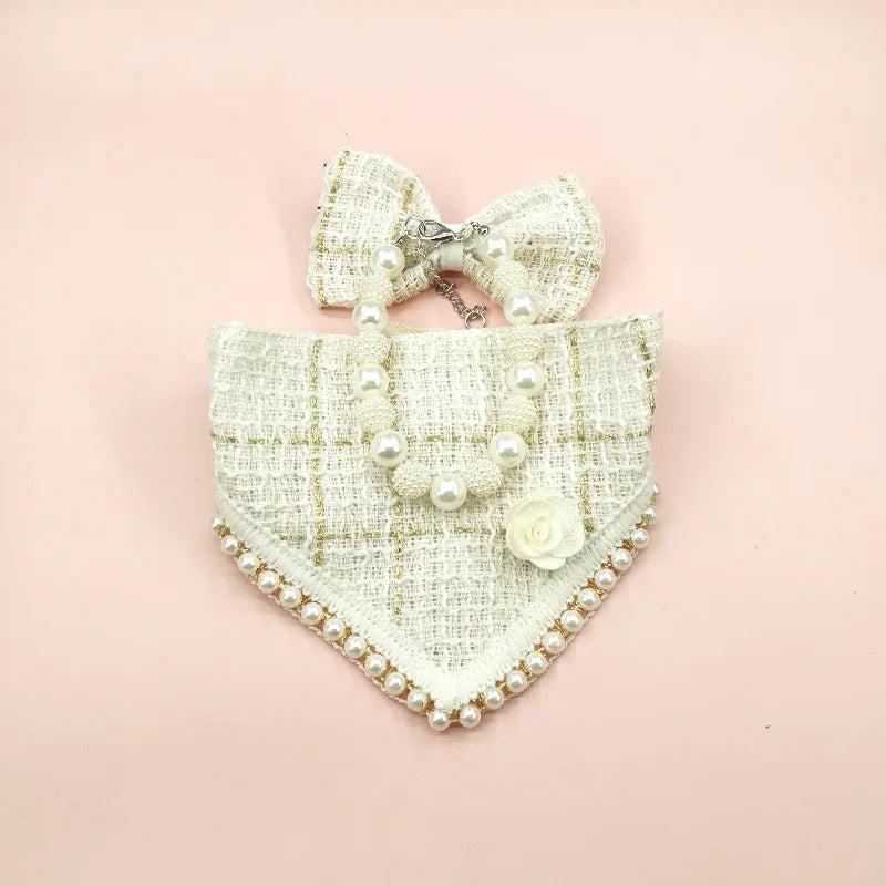 Decorative dog collar with pearls and a bow on a pink background