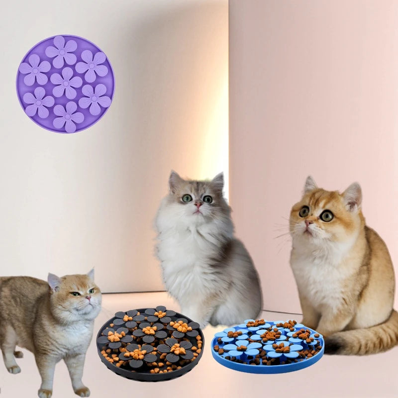 Three cats with two different pet feeding mats on a light background