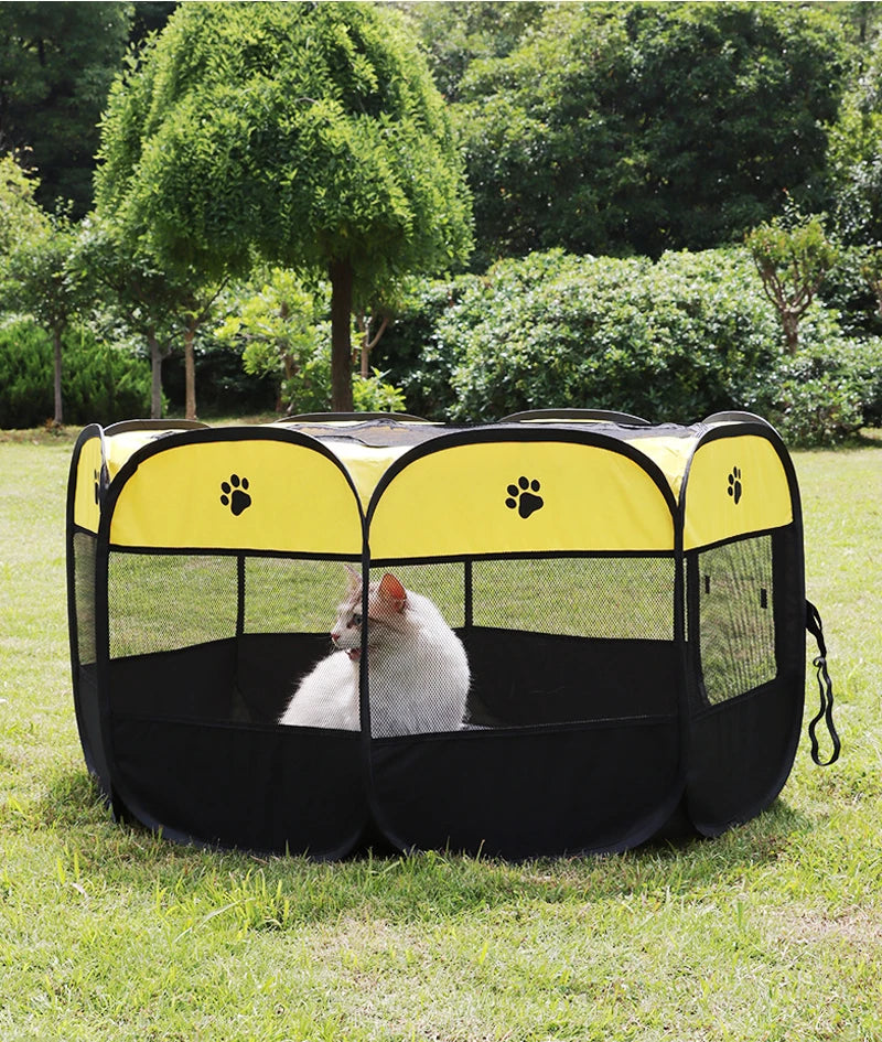 Pet playpen with a cat inside on a grassy area