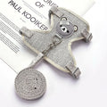 Dog muzzle and leash set on a white surface with text in the background