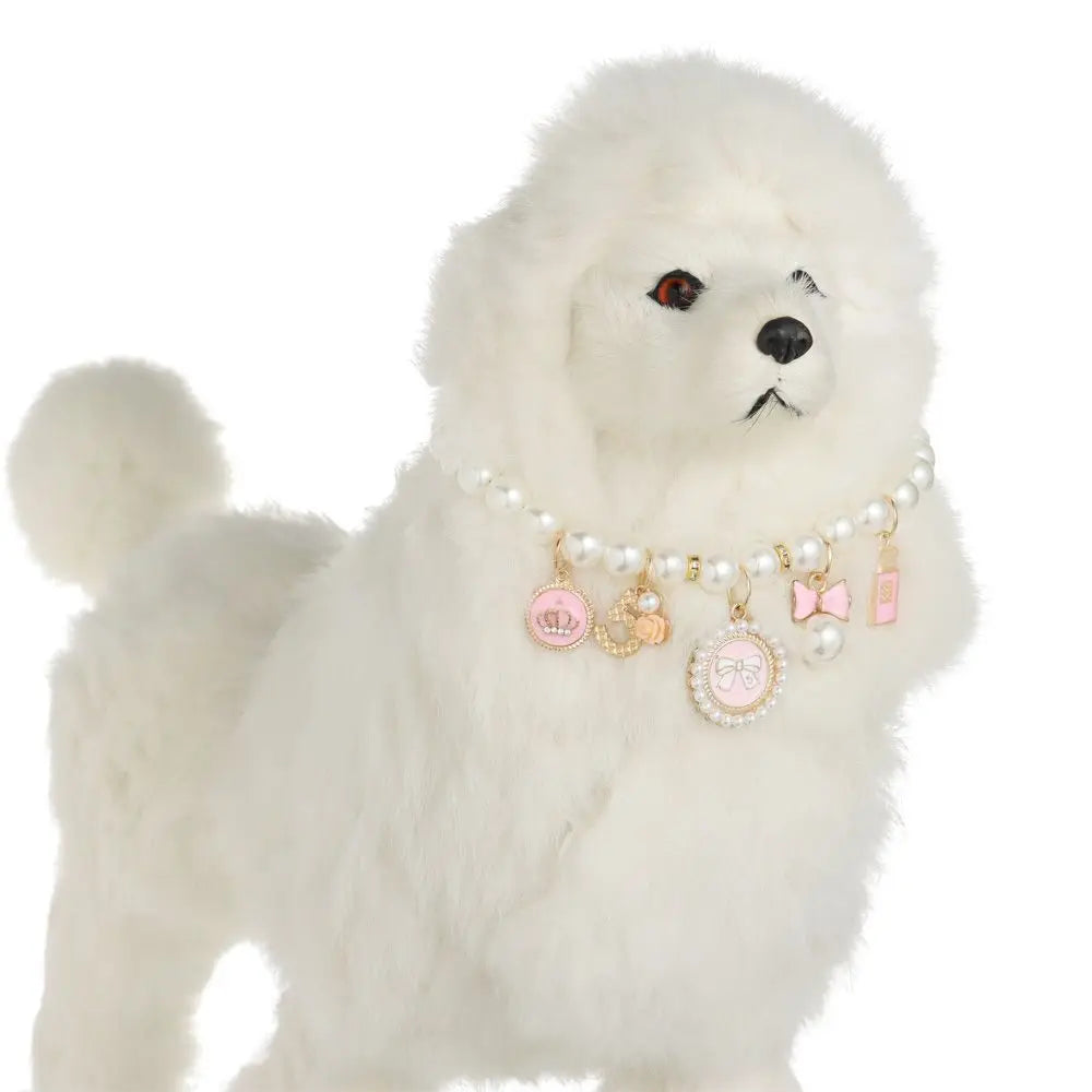 White plush dog toy with decorative charms on a white background