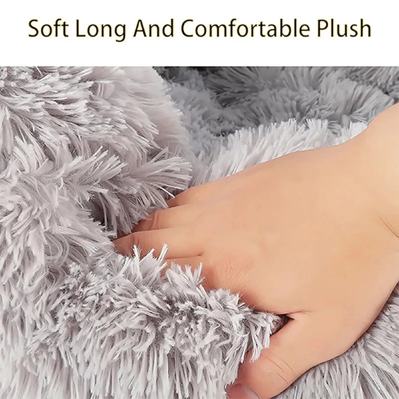 Close-up of soft, long-haired gray plush material with a hand touching it.