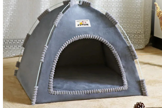 Gray pet tent on a tan carpet  with a white curtain in the background