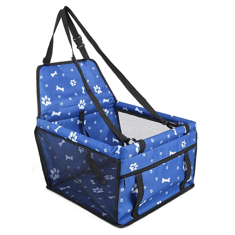 Blue pet carrier with paw and bone pattern on a white background