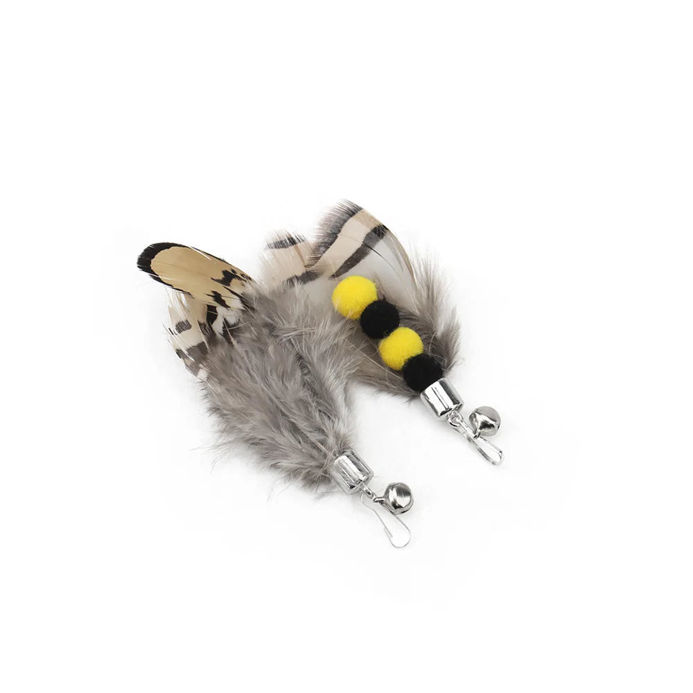 Cat toy with feathers and bells on a white background