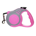 Pink and gray retractable dog leash on a white background