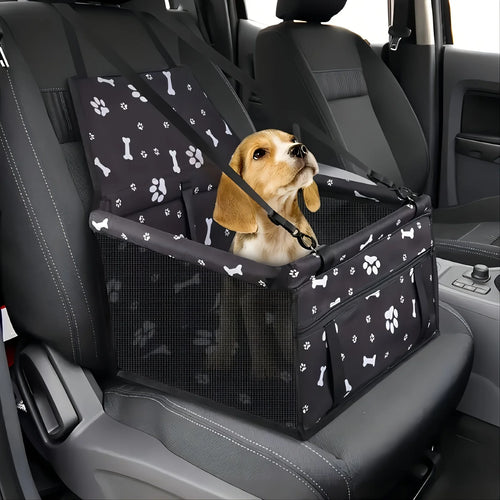 Dog in a pet seat harness inside a car with a black and white patterned cover.