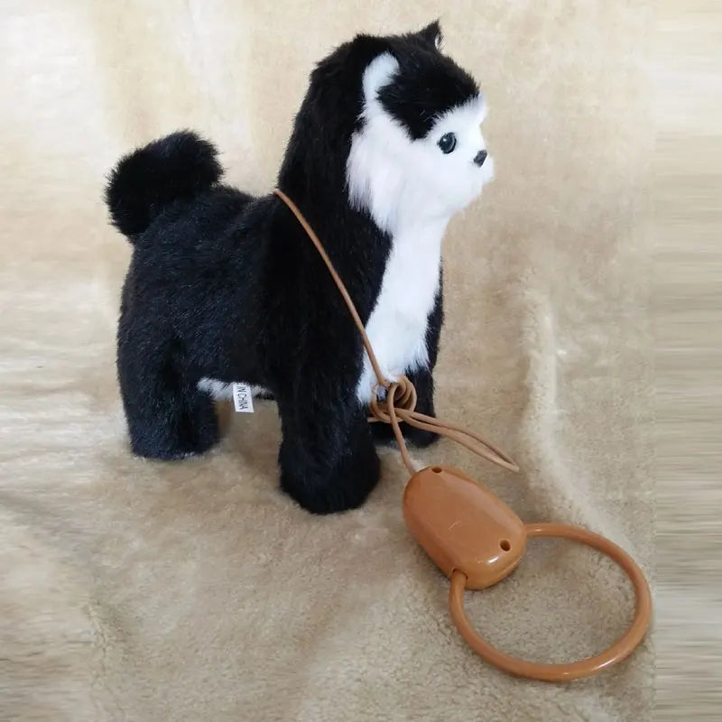 Plush dog toy on a leash with a brown handle on a beige surface