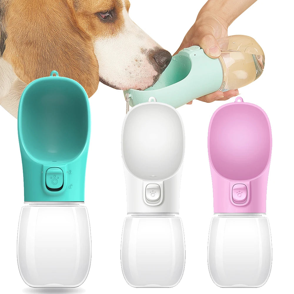 Three portable pet water bottles in teal, white, and pink held by a person with a dog drinking from one of them.