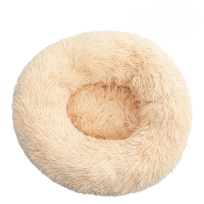 Round, plush pet bed with white background