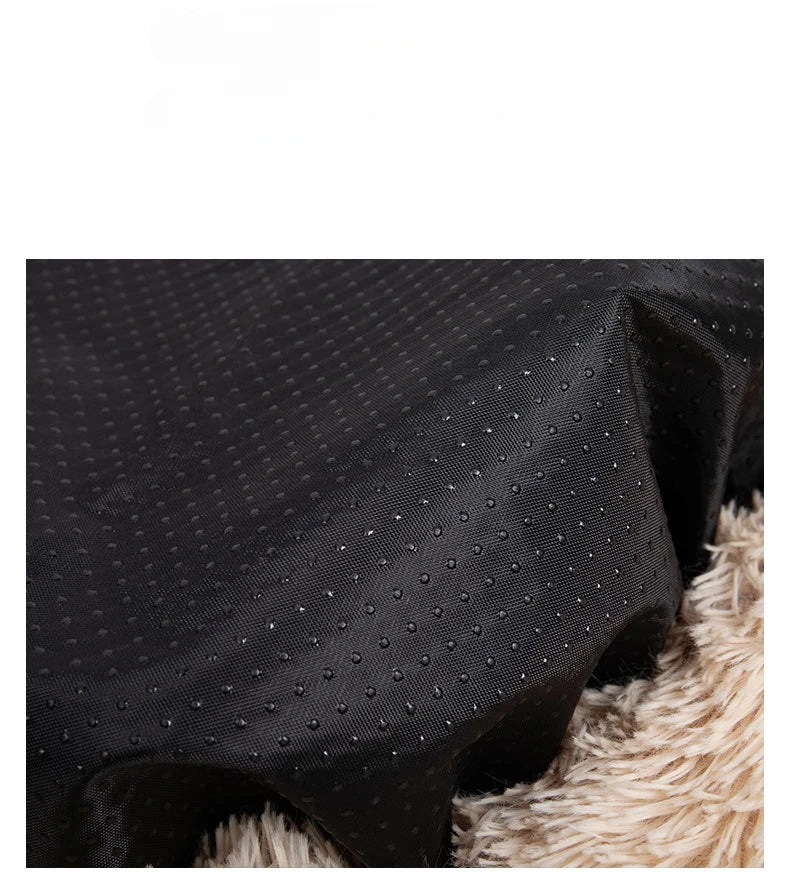 Close-up of black textured fabric with a fluffy beige surface underneath