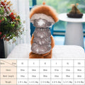 Dog wearing a silver puffer coat with fur hood indoors