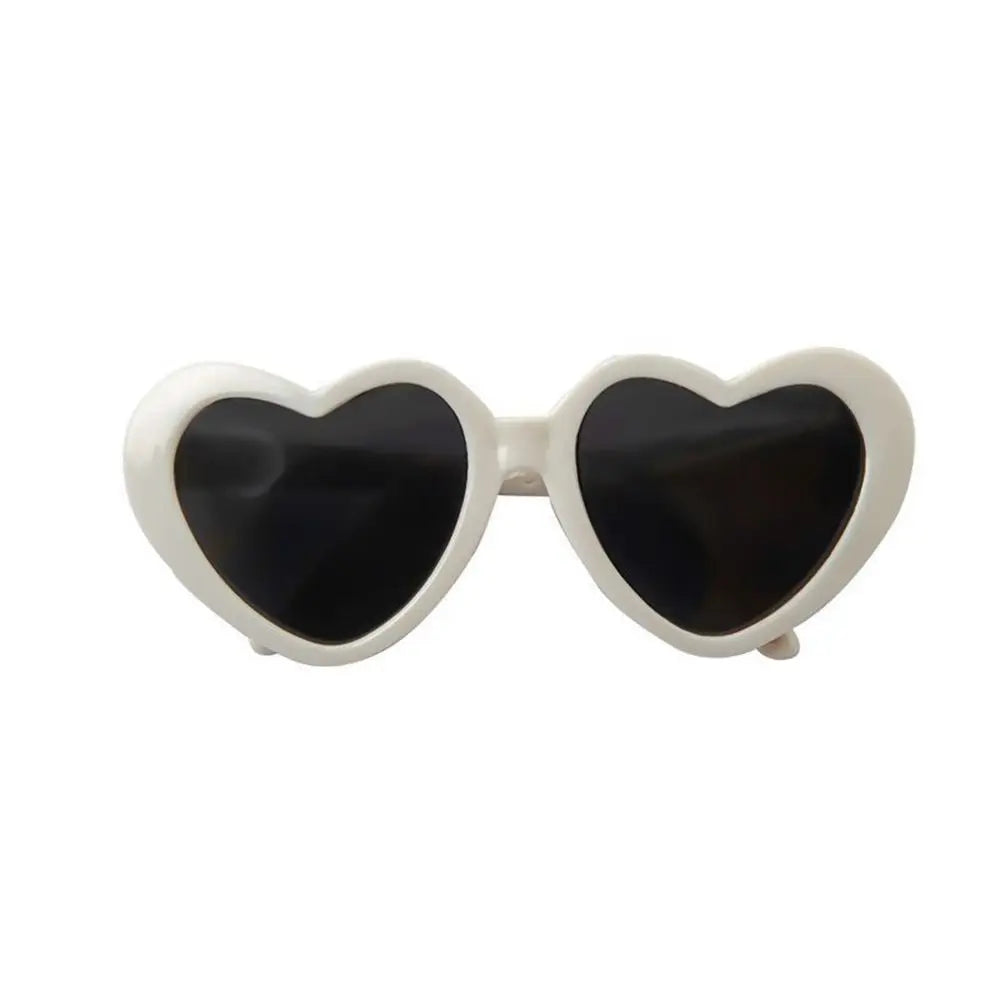 Heart-shaped sunglasses with black lenses on a white background