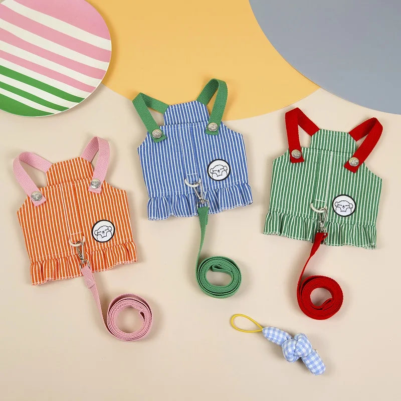 Colorful pet overalls with leashes on a beige background