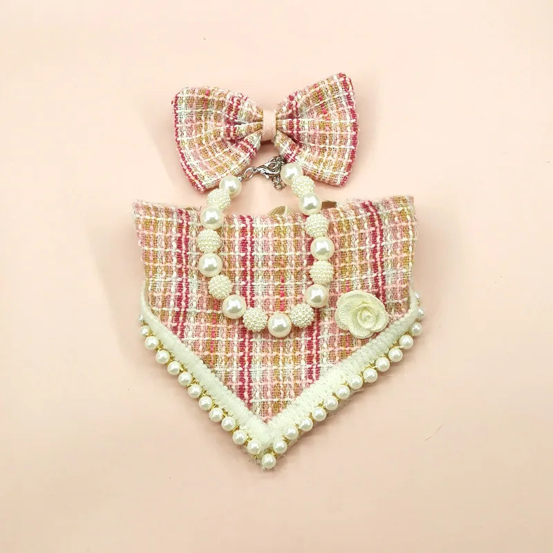 Decorative collar with pearls and a bow on a pink background