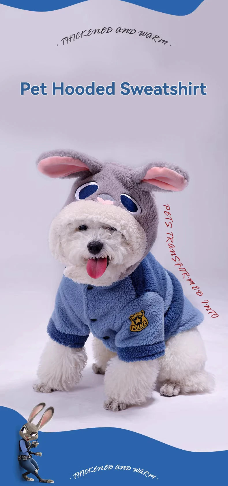 Dog wearing a blue pet hooded sweatshirt with bunny ears and goggles on a light gray background.