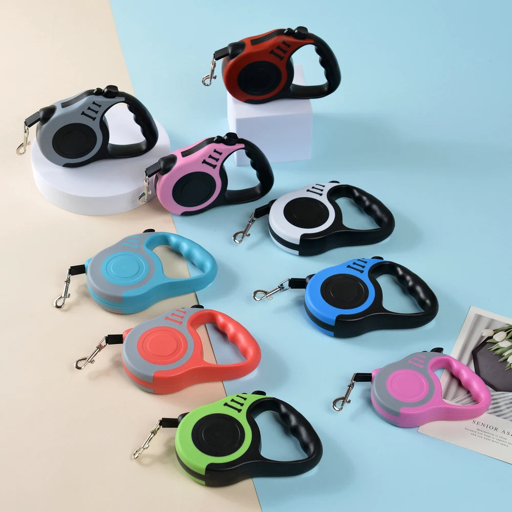 Assorted colorful retractable dog leashes on a light blue background
