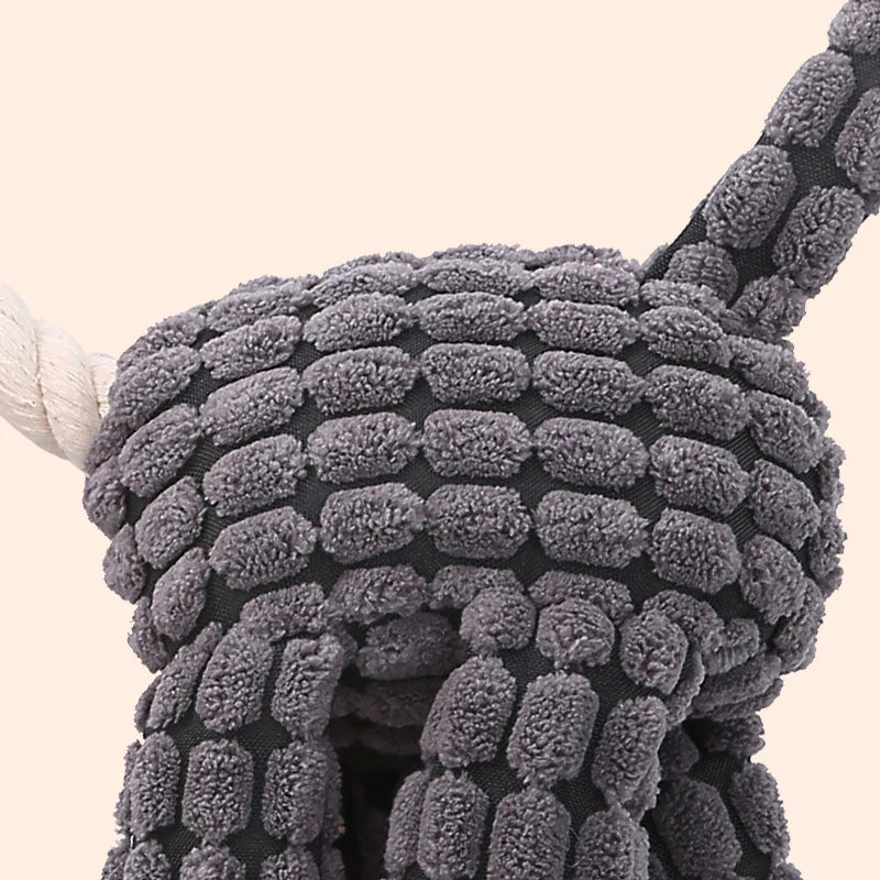 Textured gray toy over a chair on a beige background