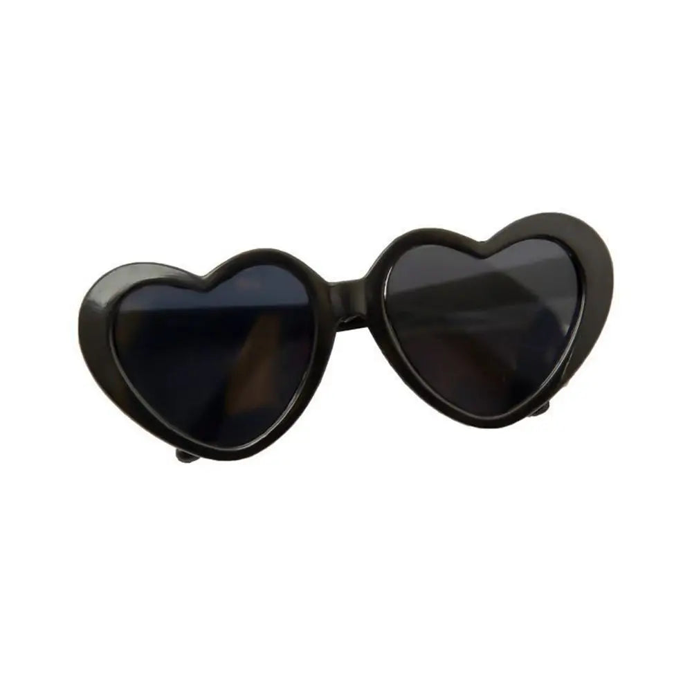 Heart-shaped sunglasses with black frames and lenses on a white background
