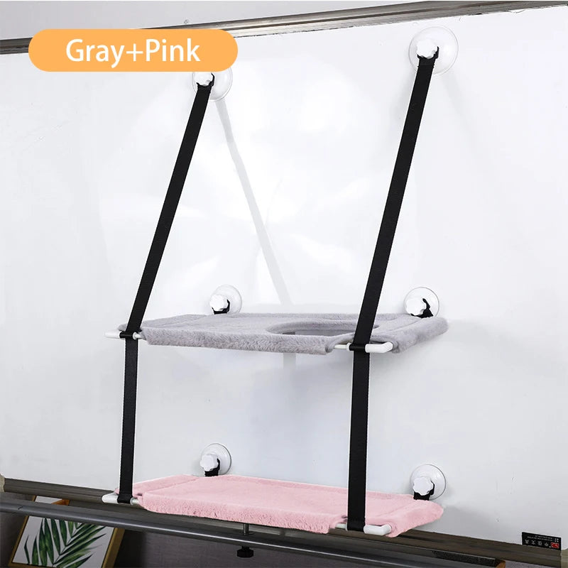 two tier pet loungers grey and pink supported by black straps suction cupped to white wall