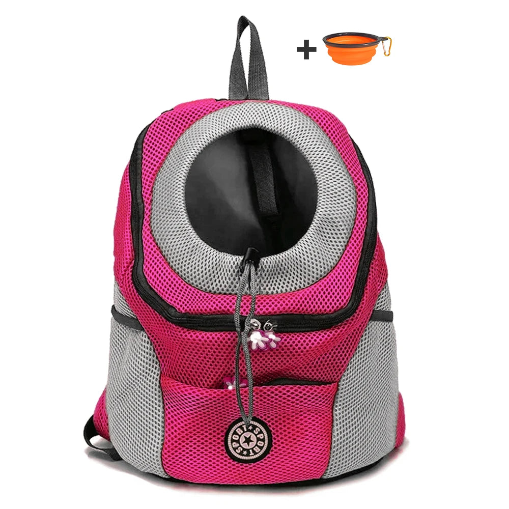 Pink and gray pet carrier backpack with a small orange bowl on a white background