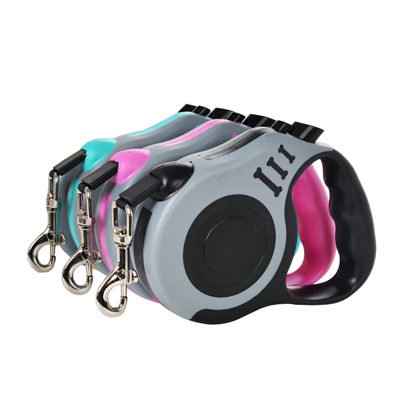 Set of four retractable dog leashes in different colors on a white background