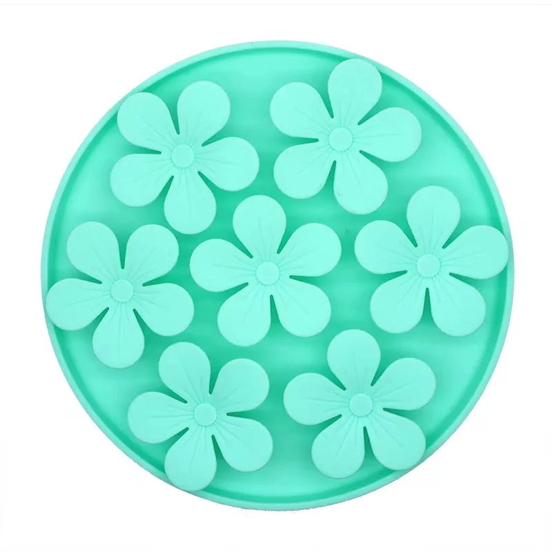 Turquoise silicone mold with flower shapes on a white background