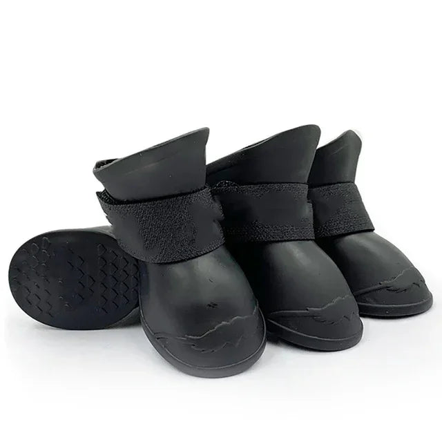 Set of black rubber boots with adjustable straps on a white background