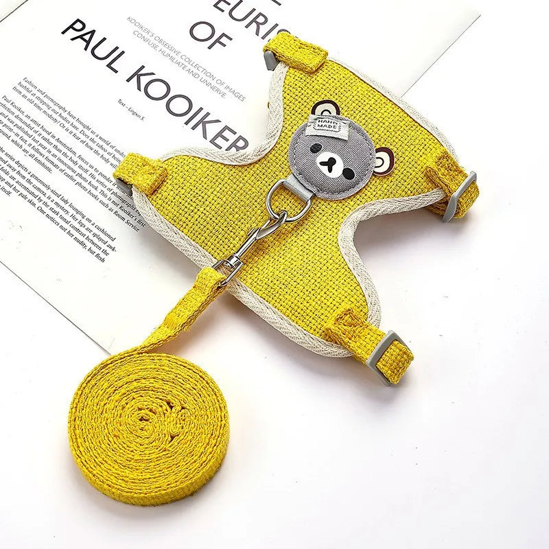 Yellow dog harness with a bear design on a white background