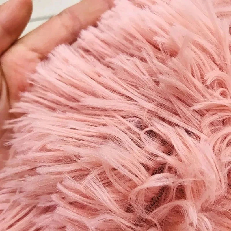 Close-up of pink fluffy fabric held in a hand