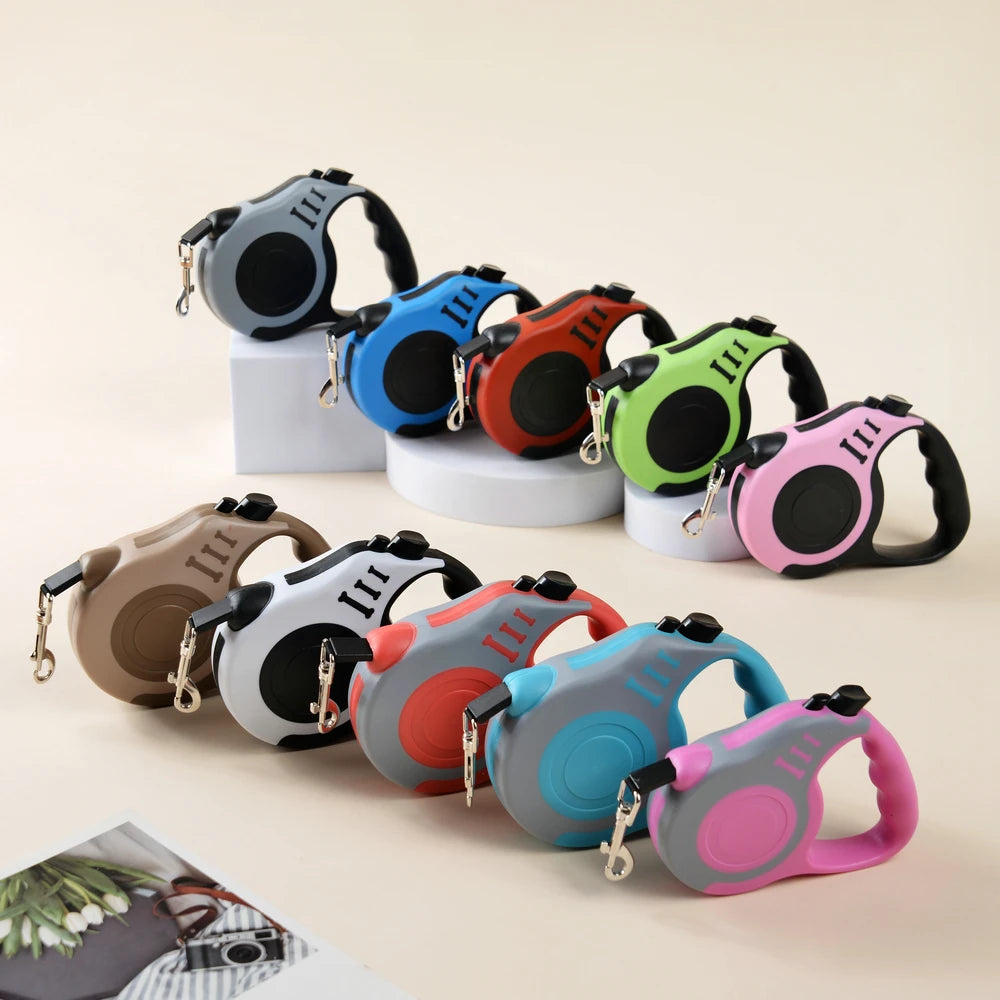 Set of colorful retractable dog leashes on a light background