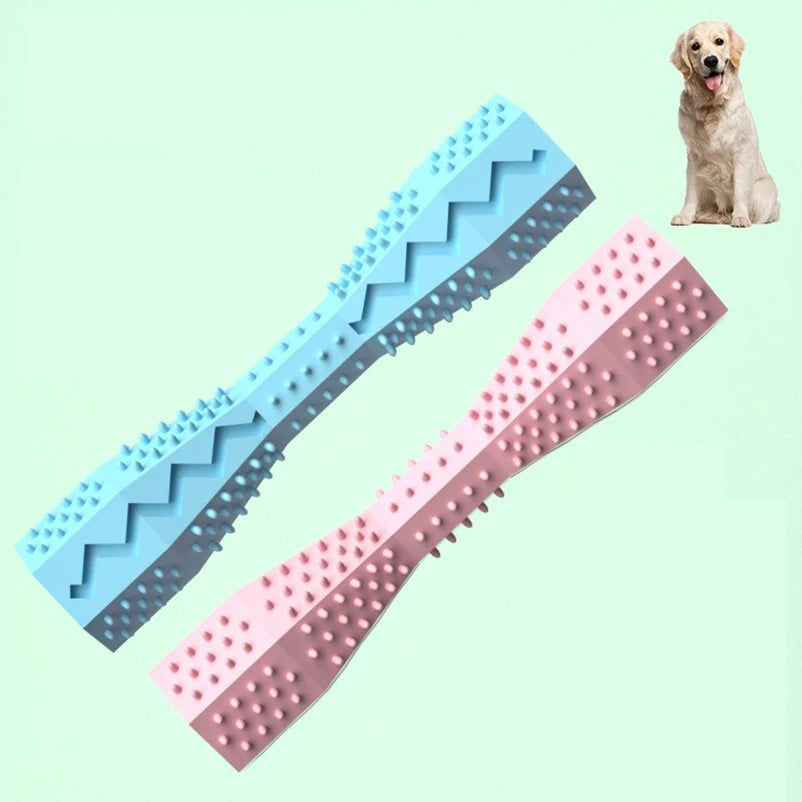 Two dog chew toys one blue and one pink, on a light green background with a dog in the corner.