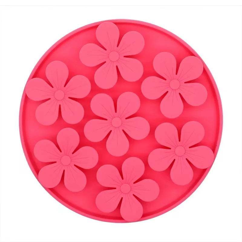 Pink silicone mold with flower shapes on a white background