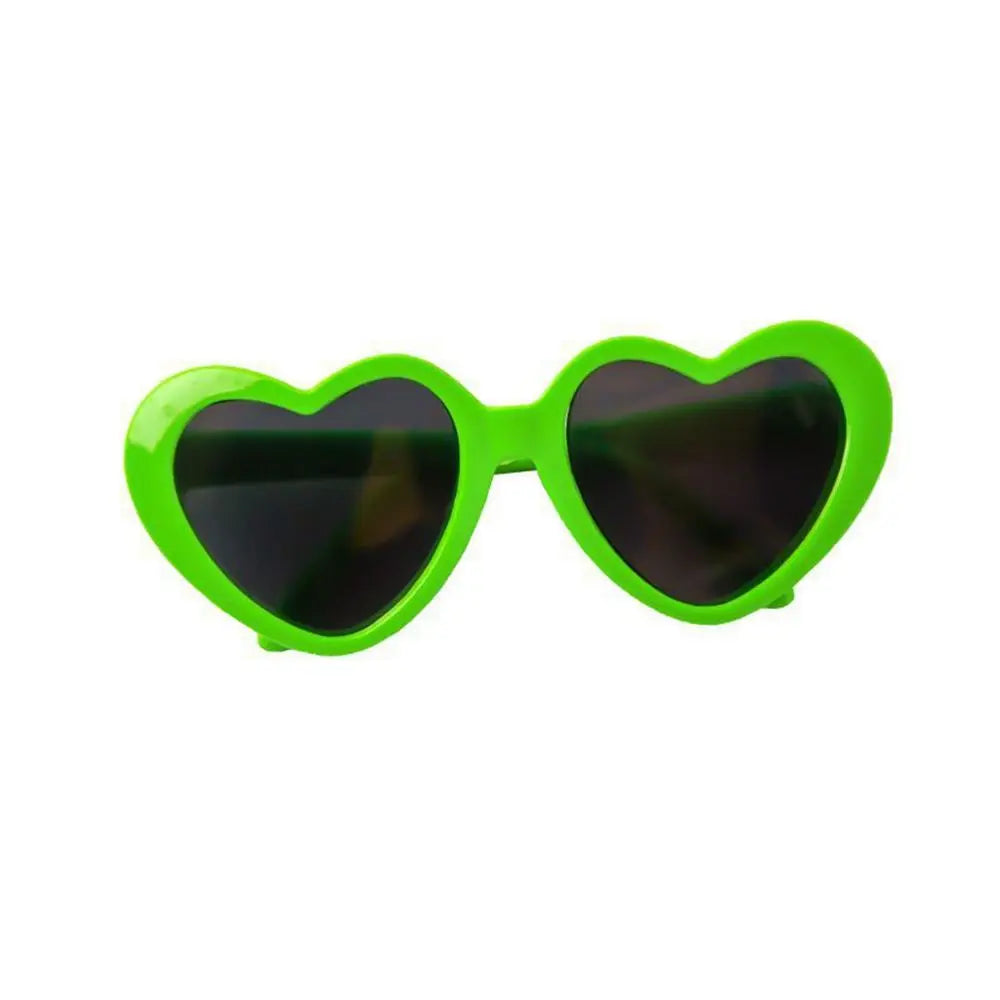 Heart-shaped sunglasses with green frames on a white background