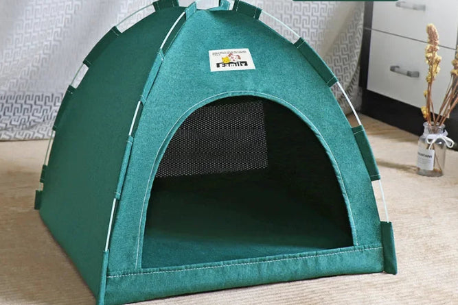 Green pet tent on a tan carpet with a white curtain in the back round 