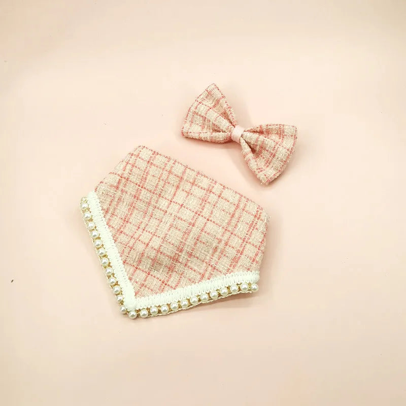 Plaid baby bib and bow headband set on a pink background