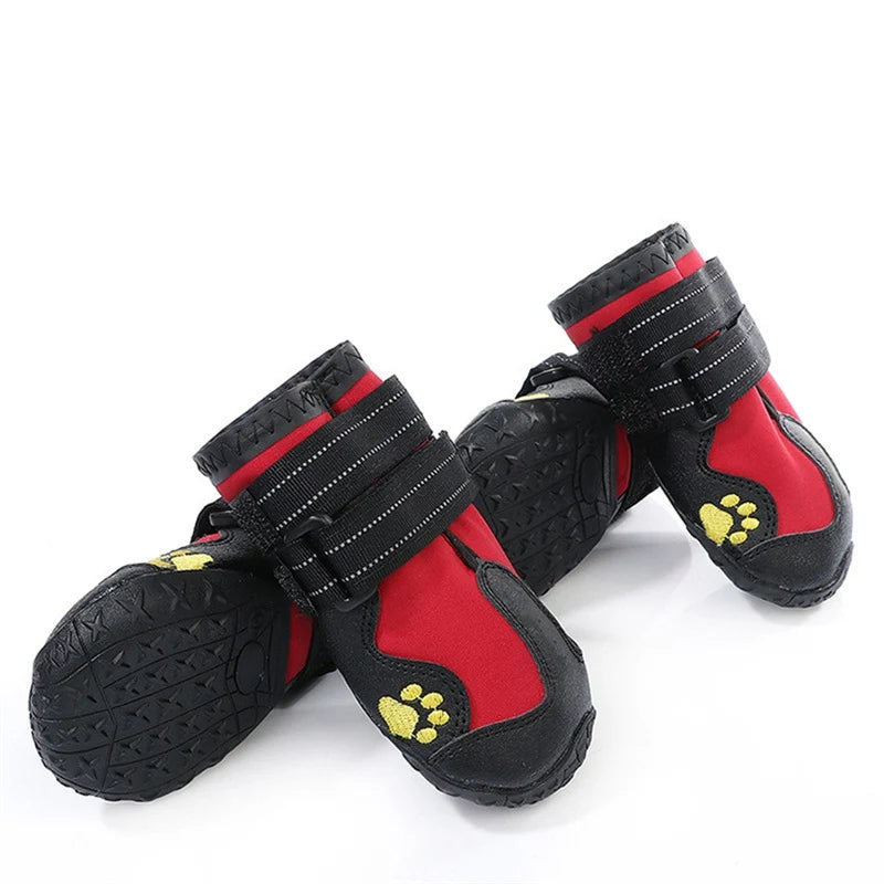 Red and black dog boots with yellow paw prints on a white background